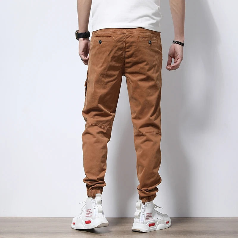Stylish men's tapered cargo joggers, reinforced for durability; merging urban aesthetic with practical comfort.