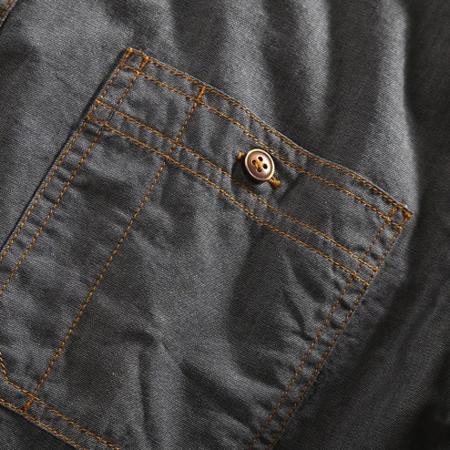 Fashionable men's collared polo, exuding urban style with its distinct chest pockets and vintage feel.