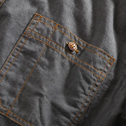 Fashionable men's collared polo, exuding urban style with its distinct chest pockets and vintage feel.