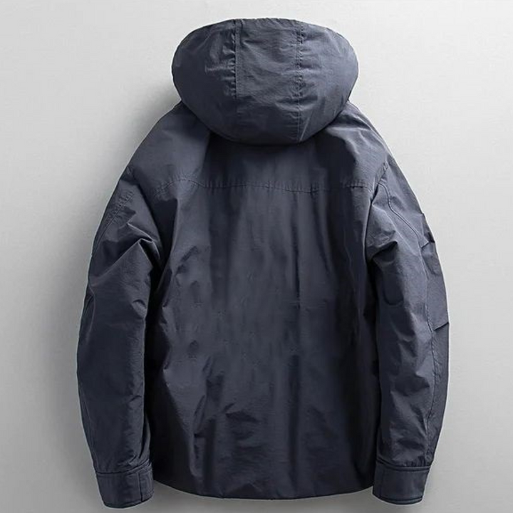 Man in a stylish, warm men's urban winter parka, perfect for navigating cold city streets in comfort.
