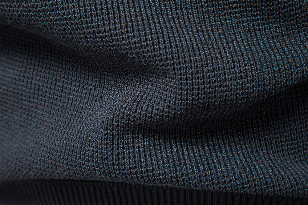 Men's waffle knit sweater layered over a collared shirt, showcasing versatile style.