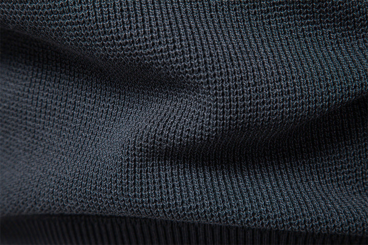 Men's waffle knit sweater layered over a collared shirt, showcasing versatile style.