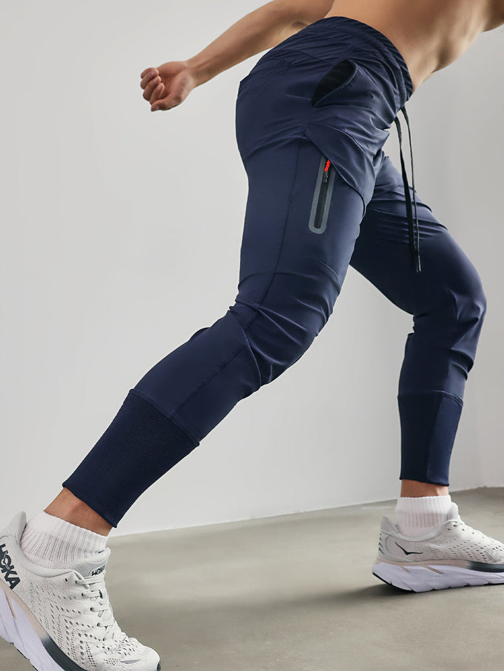Man in men's athleisure cargo joggers, casual stance, demonstrating streetwear style.