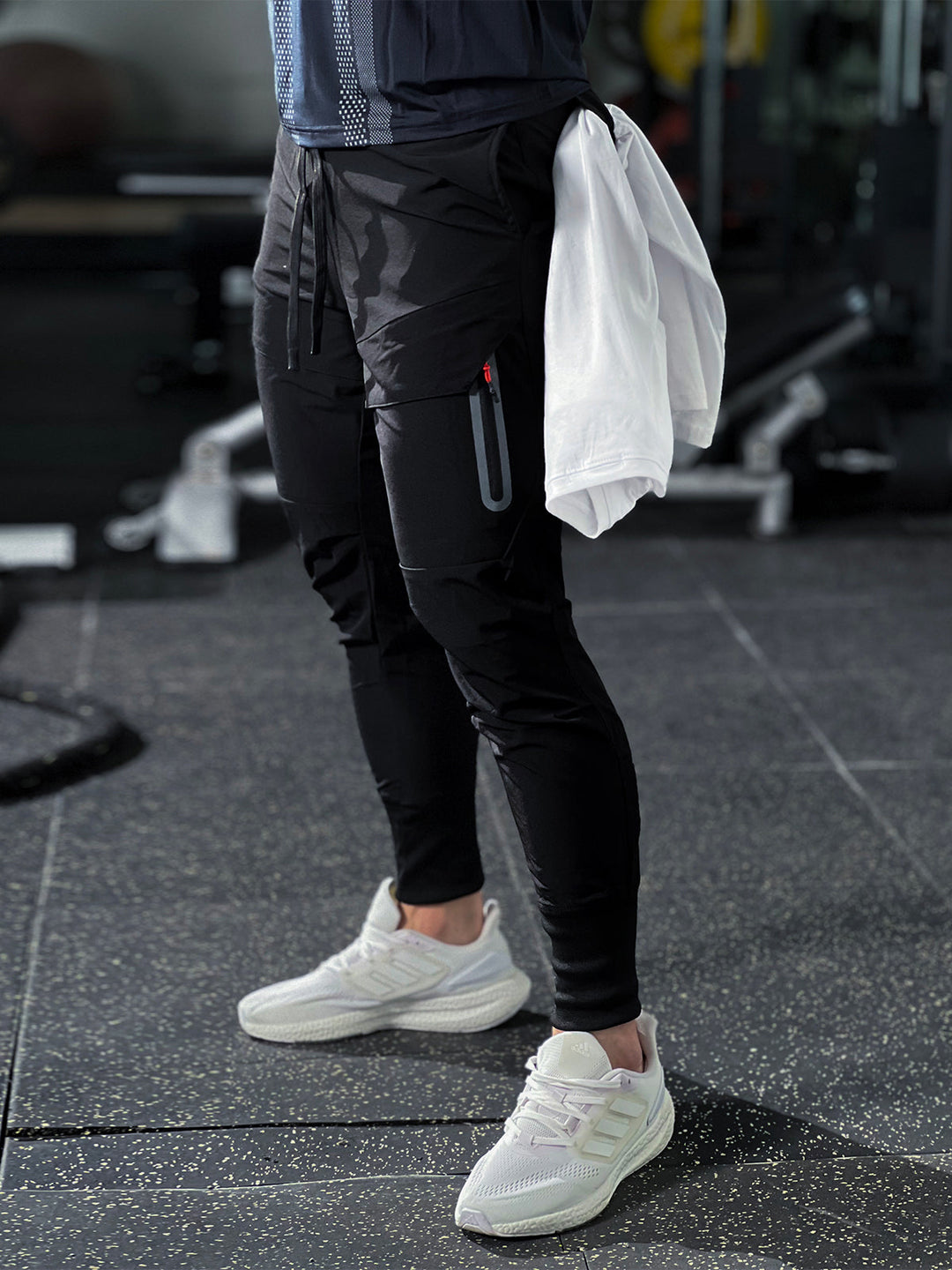 Black men's cargo joggers, performance fabric, tapered fit, utility pockets for versatile wear.