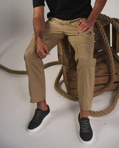 Men's multi-pocket cargo pants, side view, highlighting the practical design and relaxed fit for casual utility wear.