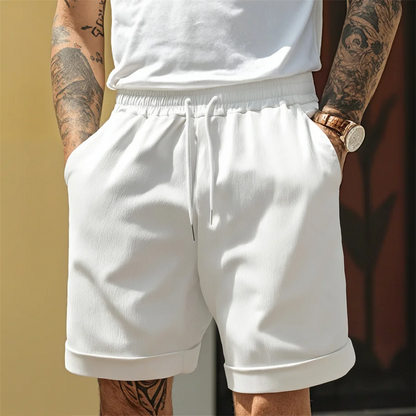 Close-up of men's comfortable cuffed shorts, showcasing breathable fabric & stylish cuff detail for warm weather.