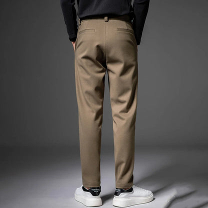 Gray men's dress pants, pleated front, perfect for office or events. Wrinkle-resistant stretch.