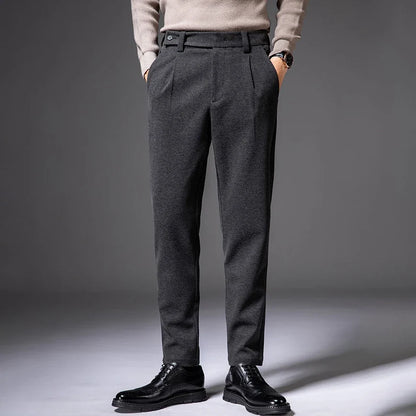 Black pleated men's casual trousers, offering comfort and style. Wrinkle-resistant stretch pants.