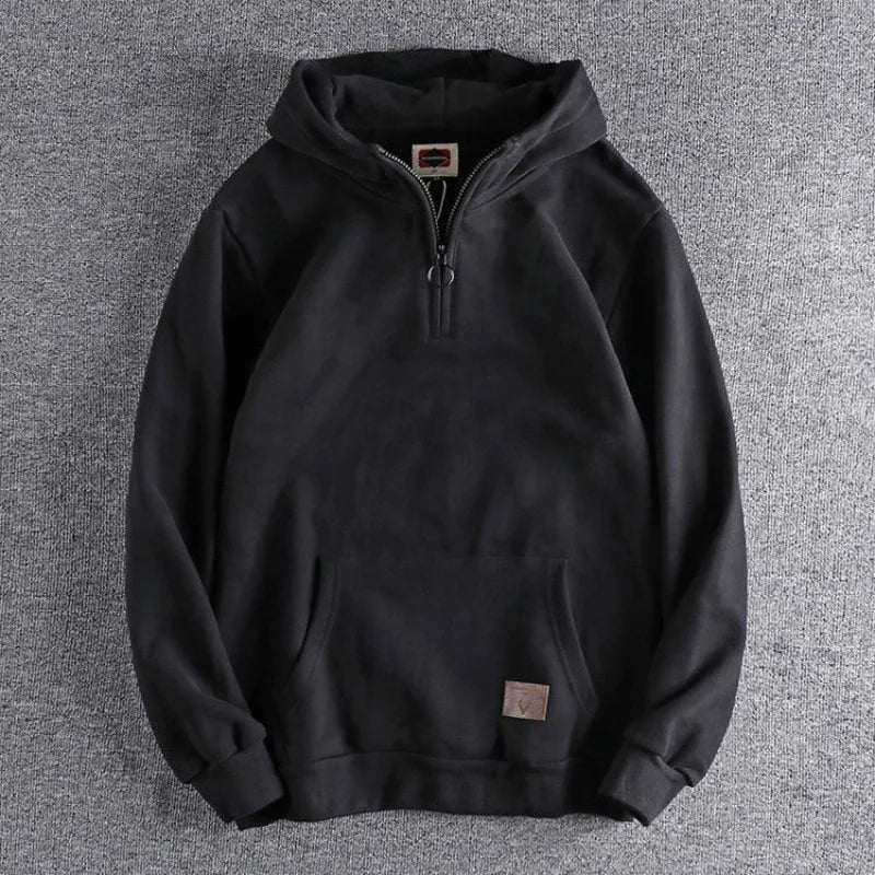 Man in relaxed fit quarter-zip hoodie, ideal for casual everyday wear, athleisure, or outdoor activities.