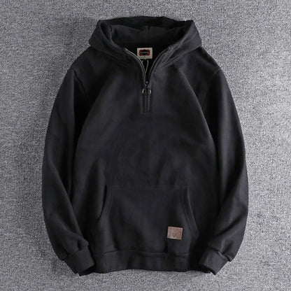Man in relaxed fit quarter-zip hoodie, ideal for casual everyday wear, athleisure, or outdoor activities.