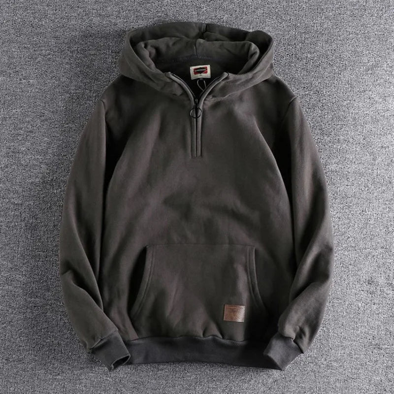Warm men's quarter-zip hoodie, an essential outerwear piece for comfortable spring and fall layering.