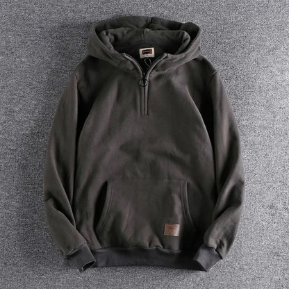 Warm men's quarter-zip hoodie, an essential outerwear piece for comfortable spring and fall layering.