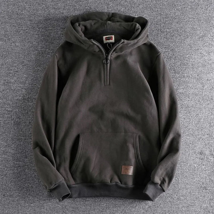 Warm men's quarter-zip hoodie, an essential outerwear piece for comfortable spring and fall layering.
