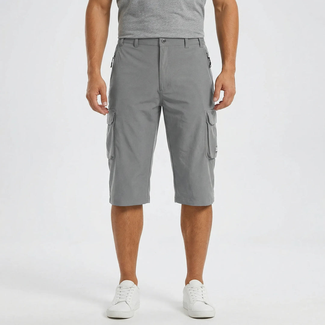 Man hiking in quick-dry cargo shorts. Comfortable & functional men's activewear, perfect for outdoor adventures.
