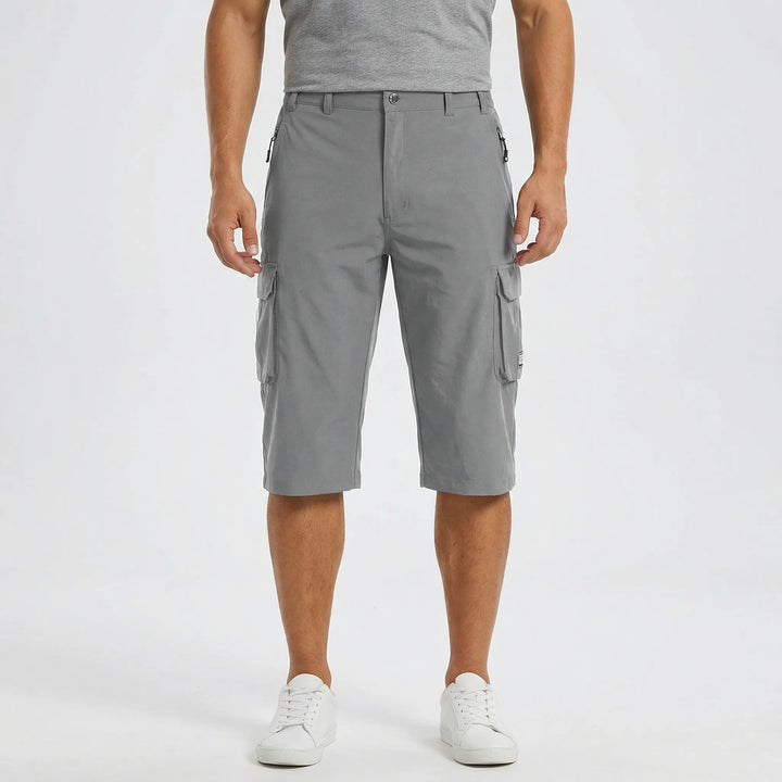 Man hiking in quick-dry cargo shorts. Comfortable & functional men's activewear, perfect for outdoor adventures.