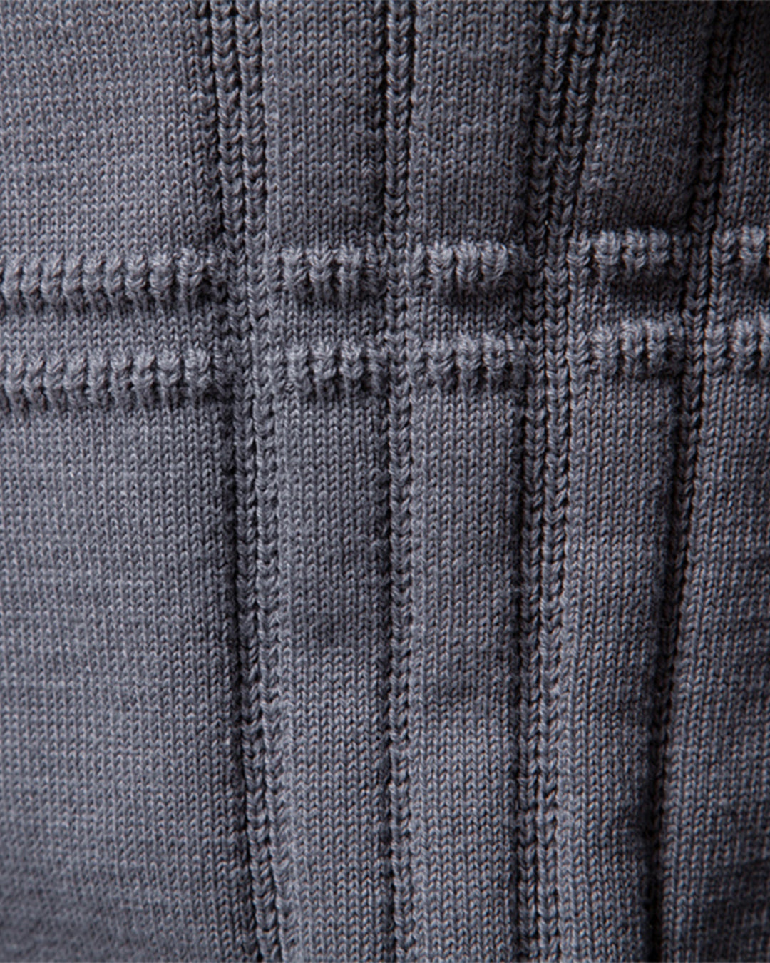 Close-up of the rich textured knit on a men's crew neck pullover sweater.