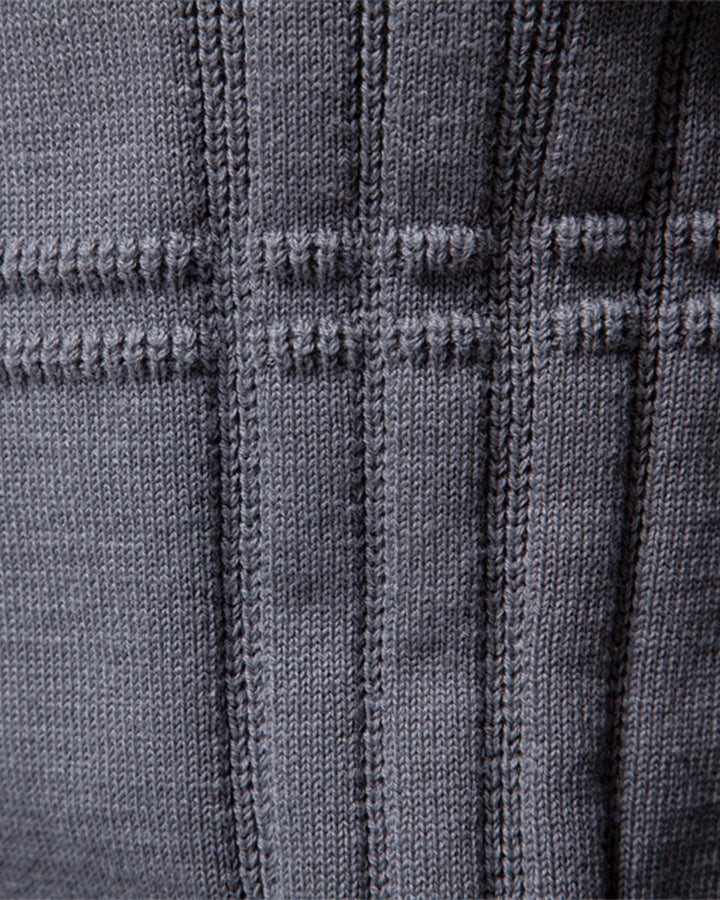 Close-up of the rich textured knit on a men's crew neck pullover sweater.