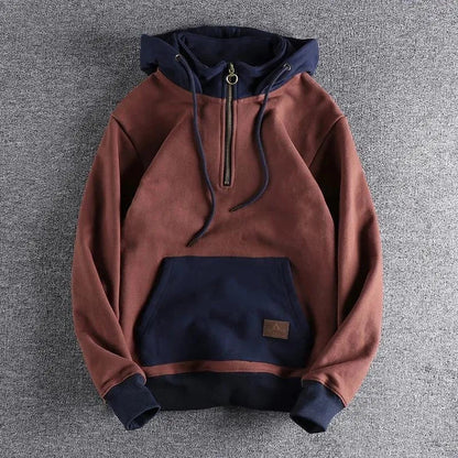 Two-tone men's hooded sweatshirt. A versatile quarter-zip pullover for casual comfort and modern urban style.
