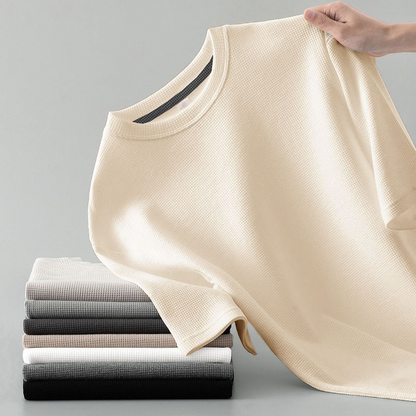 Close-up of the comfortable men's waffle knit long sleeve tee, showcasing its textured fabric and quality.