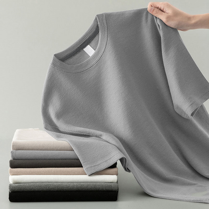Stylish man wearing a relaxed fit waffle knit long sleeve tee, a basic yet versatile top for casual daily wear.
