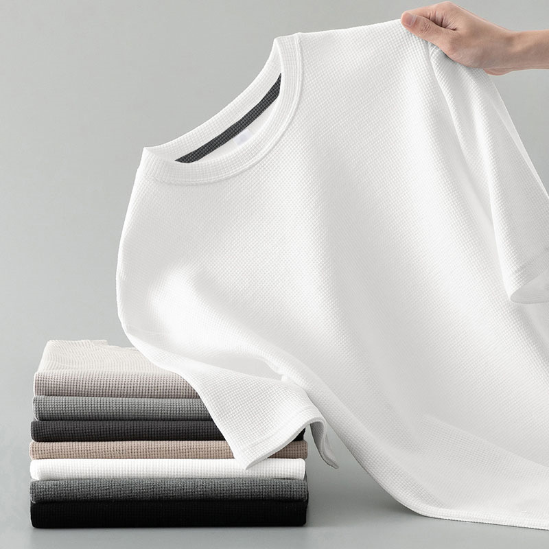Flat lay of a men's basic long sleeve waffle knit tee in a neutral tone, emphasizing its versatile, comfortable design.