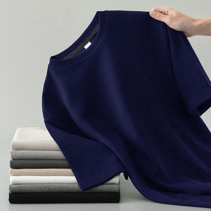 Detail shot of the soft, comfortable waffle knit fabric on a men's long sleeve tee, highlighting its quality texture.
