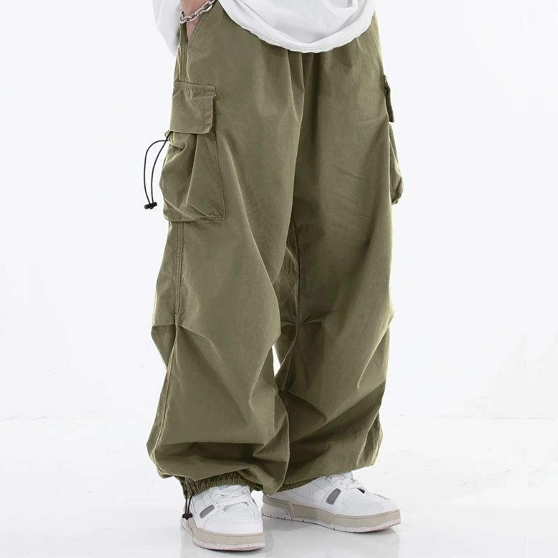 Casual men's wide-leg cargo pants, featuring drawstring cuffs and urban utility pockets.