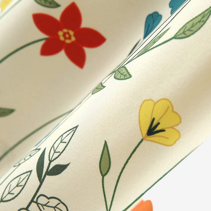 Men's vibrant floral short sleeve button-up shirt on a hanger, ready for stylish summer outings & holidays.