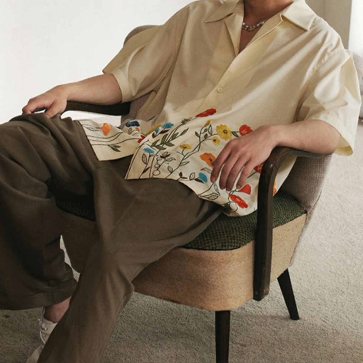 Back view of men's vibrant floral short sleeve button-up shirt, a fashionable choice for resort wear.