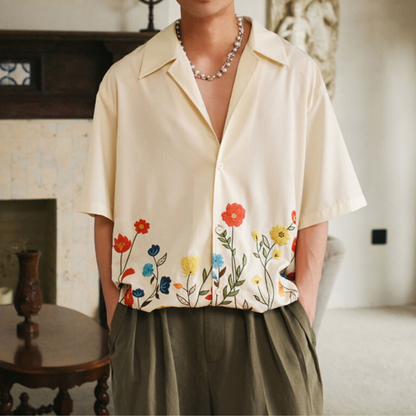 Front detail of men's vibrant floral button-up shirt, showcasing buttons and colorful casual print.