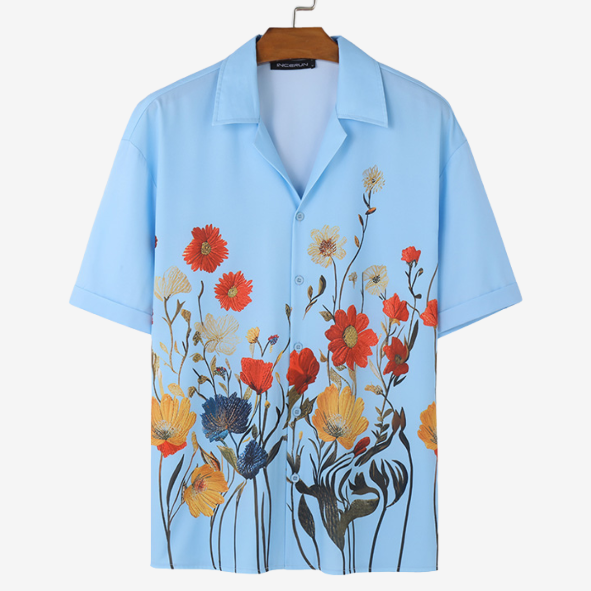 Close-up of fabric texture on men's vibrant floral short sleeve shirt, comfortable for casual resort wear.