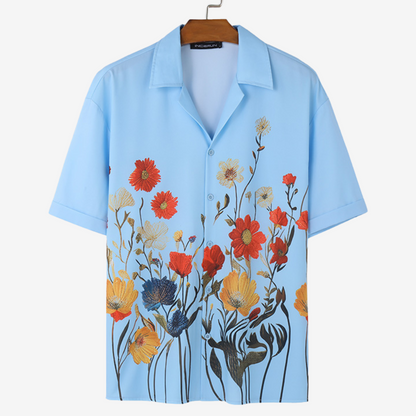 Close-up of fabric texture on men's vibrant floral short sleeve shirt, comfortable for casual resort wear.