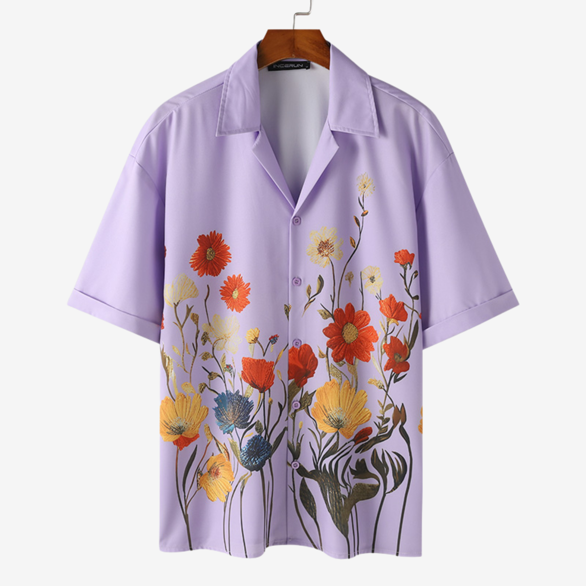 Short sleeve detail of men's vibrant floral button-up shirt, great for summer everyday style.