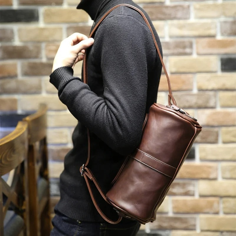 Practical men's vintage barrel shoulder bag. PU leather cross-body, durable and stylish travel accessory.