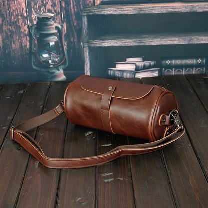 Stylish PU leather men's barrel bag. Vintage design, durable shoulder & cross-body accessory.