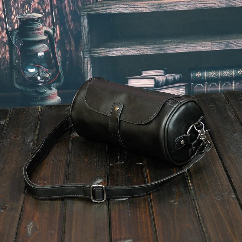 Durable men's vintage barrel shoulder bag for travel. PU leather cross-body accessory, stylish.