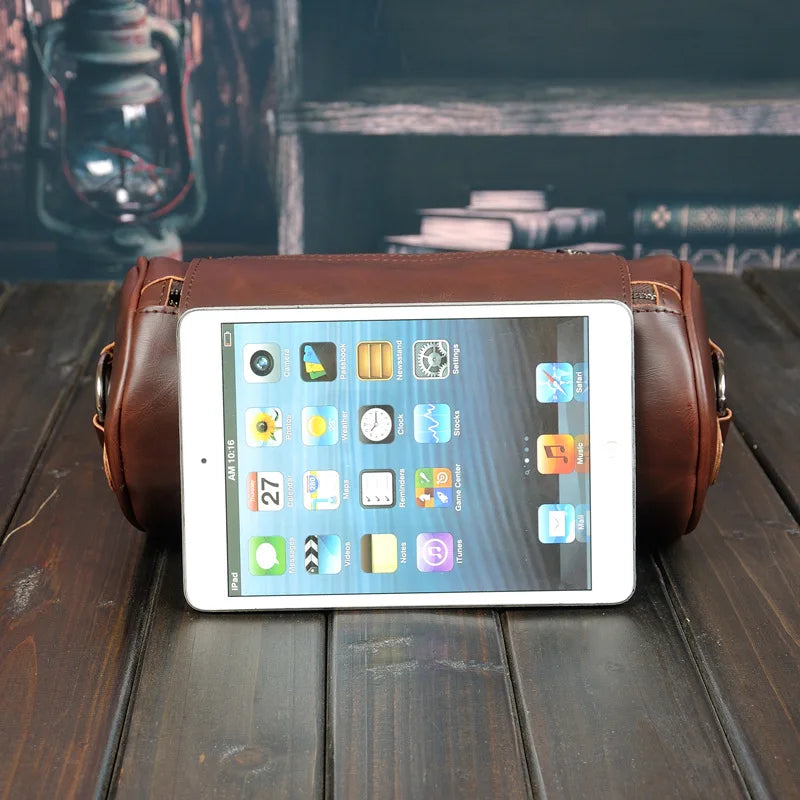 Detailed view of men's vintage barrel shoulder bag. Durable PU leather, stylish cross-body design.