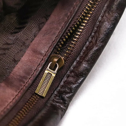 Compact men's vintage leather bifold wallet with secure snap closure, perfect for travel or daily use.