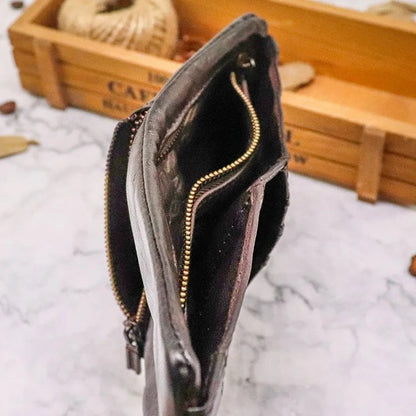 Open men's vintage leather bifold wallet, revealing card slots and currency pocket. Slim profile.