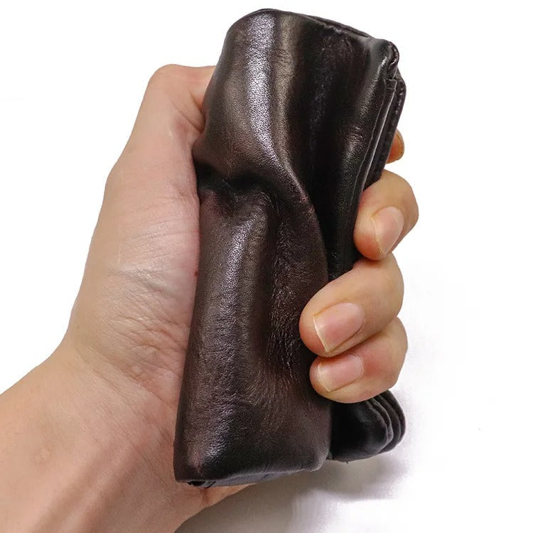 Textured vintage brown leather men's bifold wallet, slim & durable for daily use. Perfect everyday carry.
