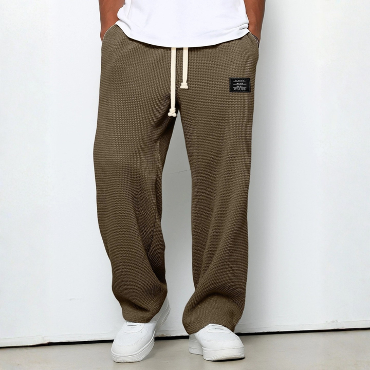 Textured waffle knit men's pants, comfortable drawstring trousers for relaxed casual wear.