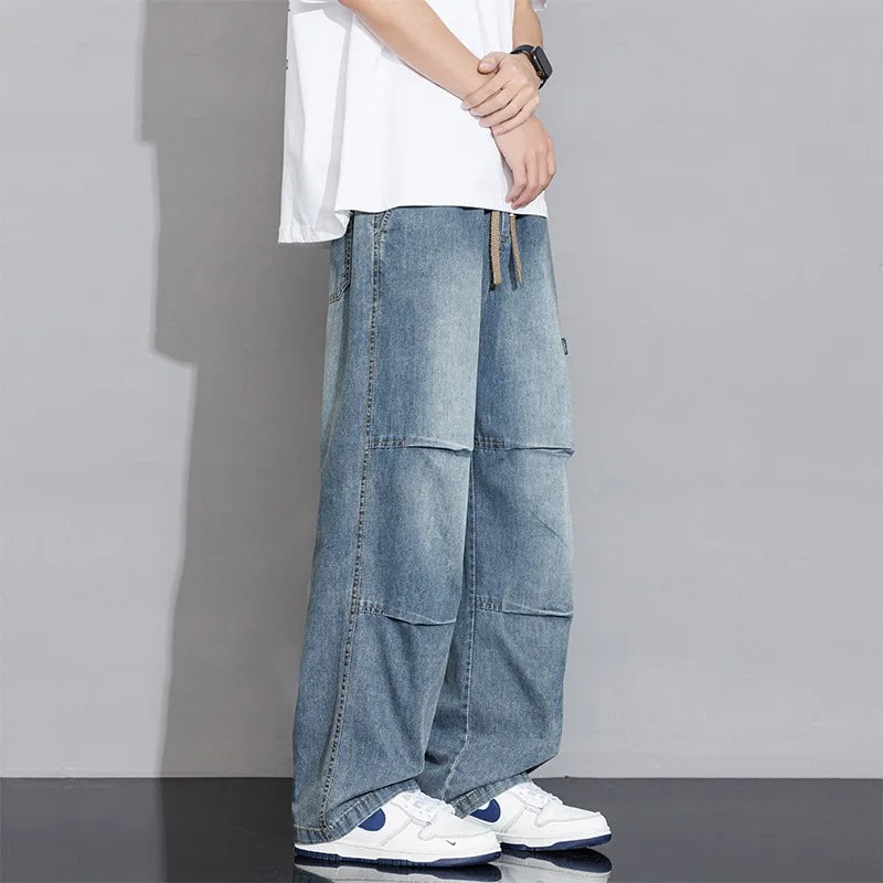 Fashionable men's washed wide-leg cargo jeans with deep pockets & drawstring waist for comfort.