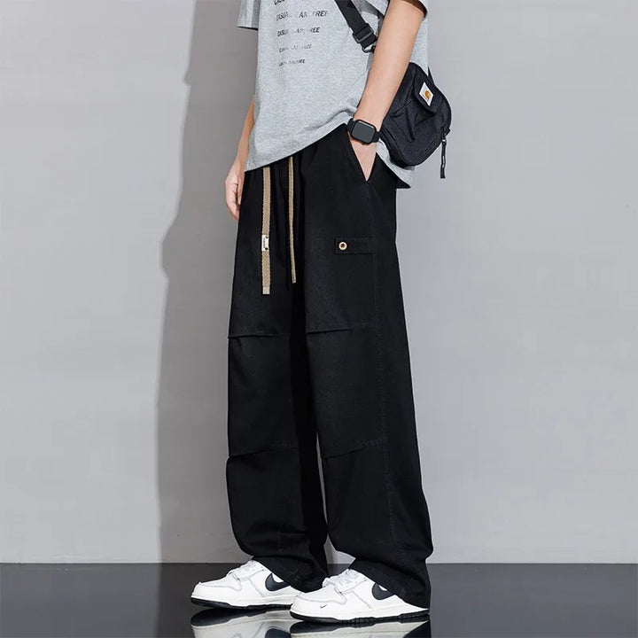 Men's relaxed fit washed wide-leg jeans with cargo pockets & a comfortable drawstring waistband.