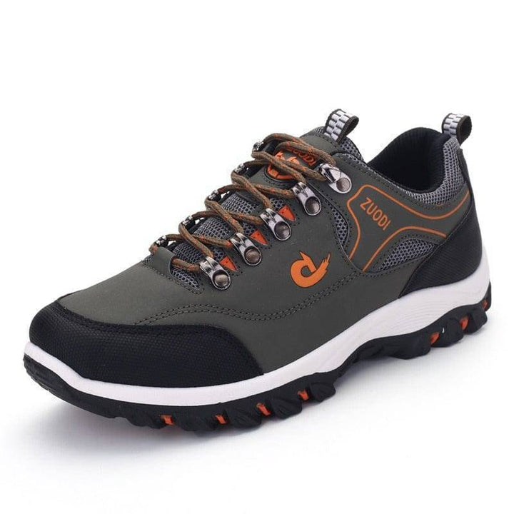 Close-up of men's waterproof hiking shoe leather texture and detailed stitching, outdoor footwear