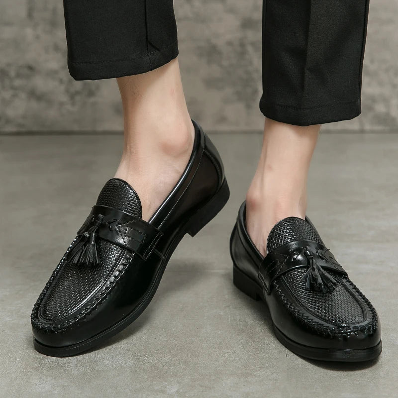 Classic men's slip-on loafers with intricate woven detail and elegant tassel accents.