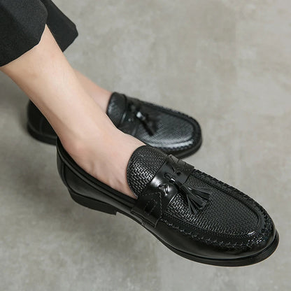 Stylish men's dress loafers featuring a unique woven texture and sophisticated tassel.