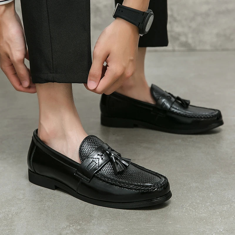 Comfortable men's casual loafers with a distinctive woven design and decorative tassels.