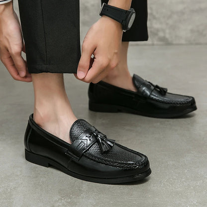Comfortable men's casual loafers with a distinctive woven design and decorative tassels.