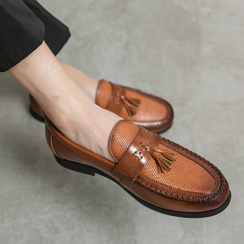 Men's slip-on tassel loafers with a distinctive woven texture for modern style and ease.