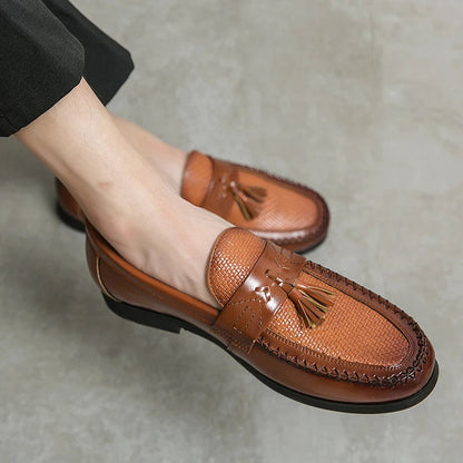 Men's slip-on tassel loafers with a distinctive woven texture for modern style and ease.